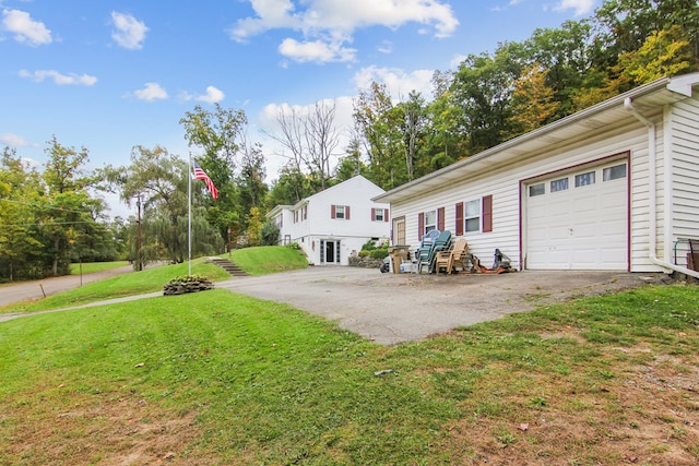 view of front of house with a garage and a front lawn