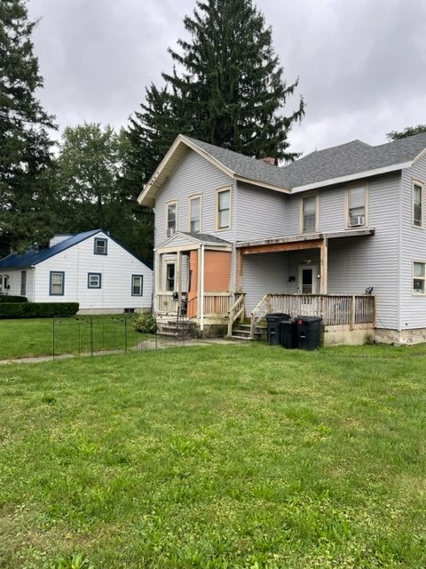 rear view of house with a yard