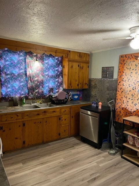 kitchen featuring light hardwood / wood-style flooring, a textured ceiling, and sink