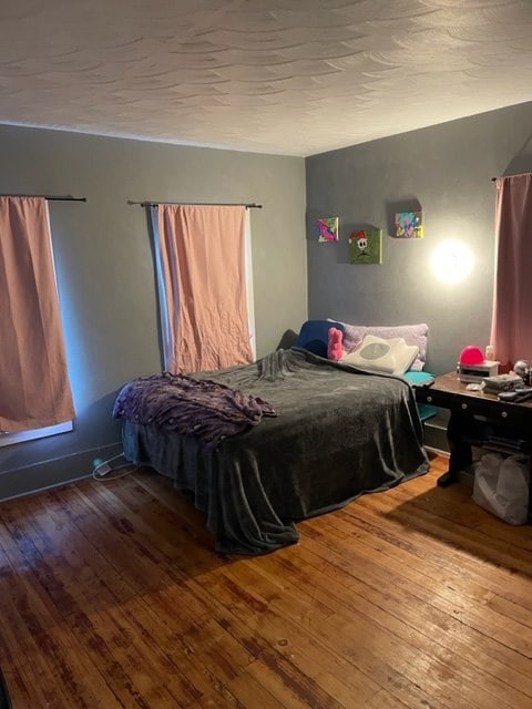 bedroom with wood-type flooring