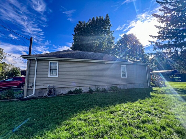 view of side of property with a yard