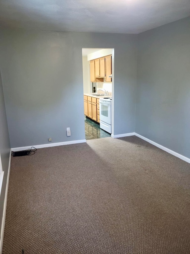 empty room with sink and dark carpet