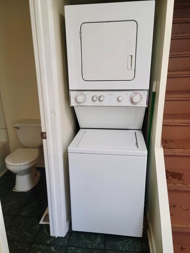 washroom with stacked washer and dryer