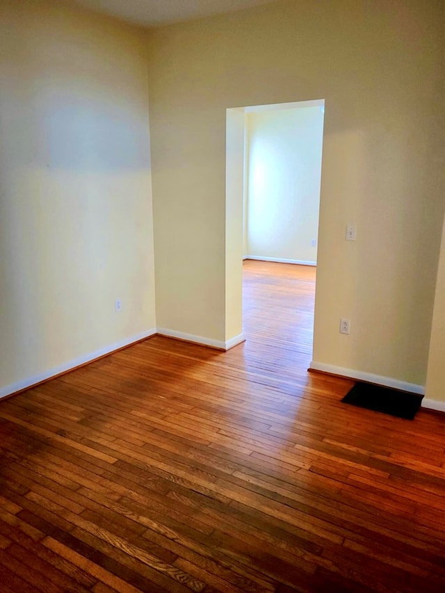 unfurnished room with wood-type flooring