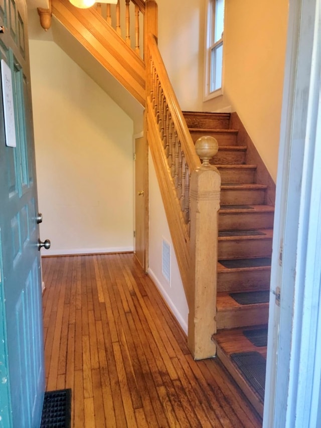 stairway featuring wood-type flooring