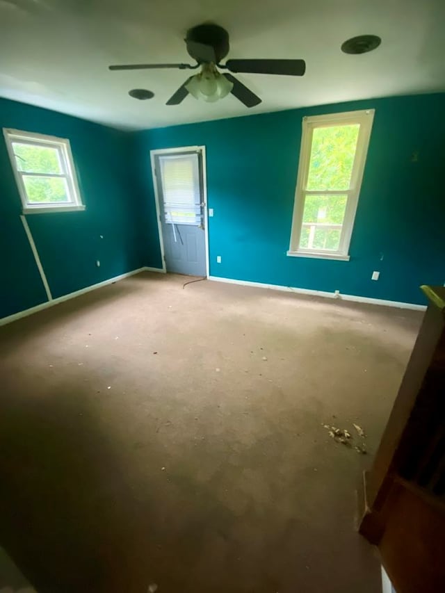 unfurnished bedroom featuring multiple windows and ceiling fan