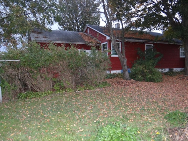 view of side of home with a lawn