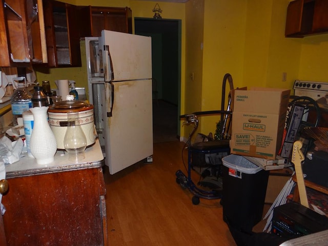 kitchen with light hardwood / wood-style flooring and white fridge