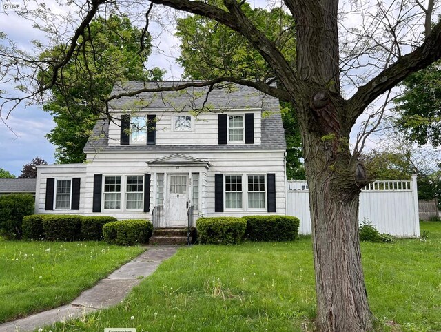 colonial home with a front lawn