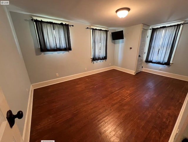 unfurnished room with dark hardwood / wood-style floors