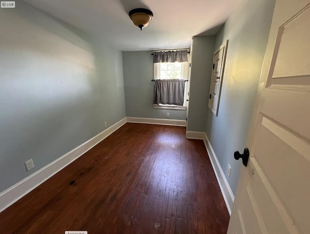 spare room with dark wood-type flooring