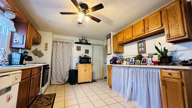 kitchen with ceiling fan, white appliances, a textured ceiling, and light tile patterned floors