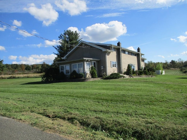 view of property exterior with a lawn