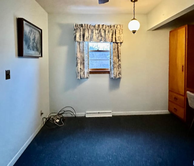 carpeted spare room with a baseboard radiator