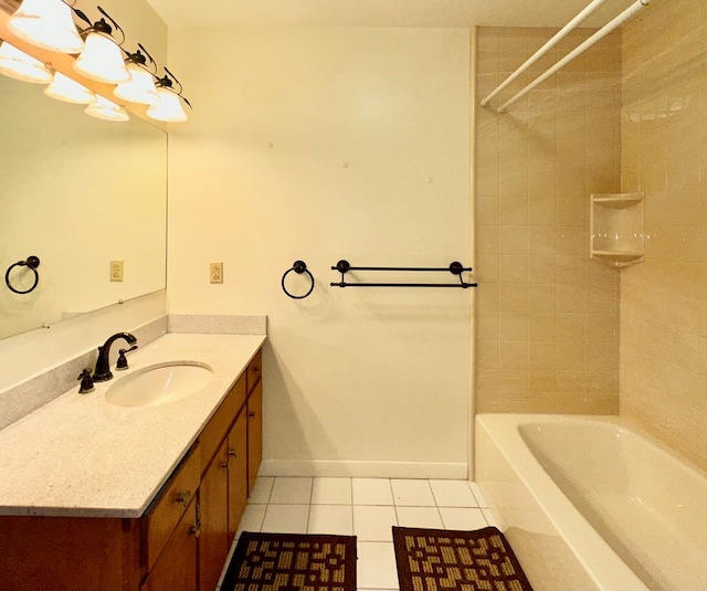 bathroom with tile patterned flooring, vanity, and tiled shower / bath