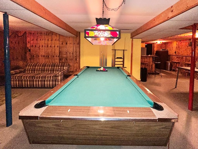 recreation room featuring carpet, bar area, and wood walls