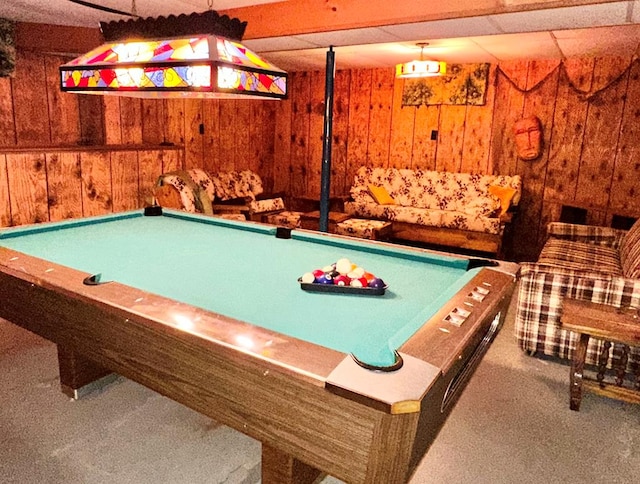 recreation room featuring carpet and wooden walls