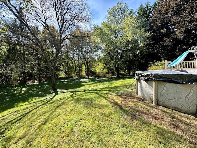 view of yard with a covered pool