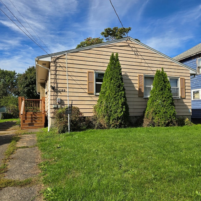 view of side of home featuring a lawn