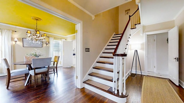 staircase with hardwood / wood-style flooring, ornamental molding, and a chandelier