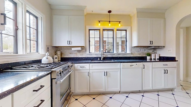 kitchen with stainless steel range, white dishwasher, a healthy amount of sunlight, and sink