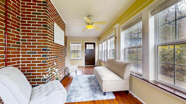 sunroom / solarium featuring ceiling fan