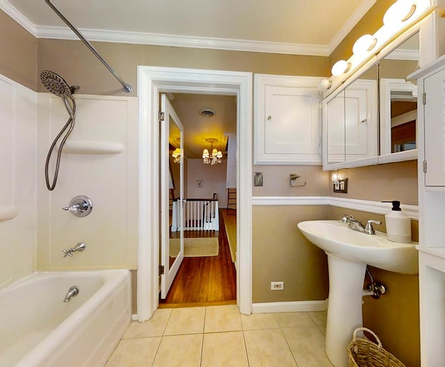 bathroom with tile patterned floors, crown molding, and bathtub / shower combination