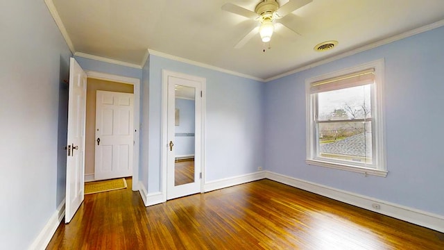 spare room featuring dark hardwood / wood-style flooring, ceiling fan, and ornamental molding