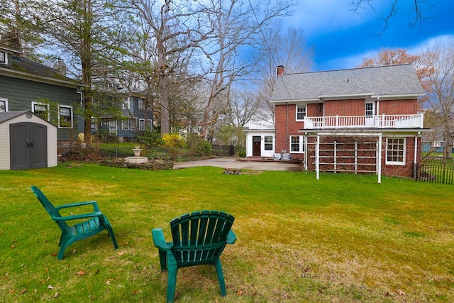 view of yard with a patio and a storage shed