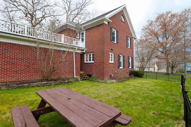 exterior space featuring a yard and a wooden deck