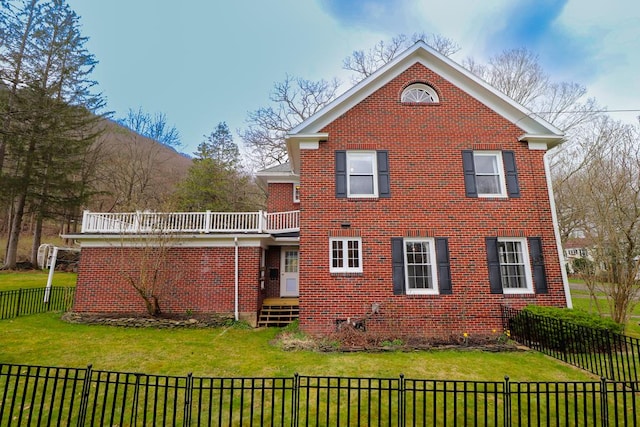 rear view of house featuring a lawn