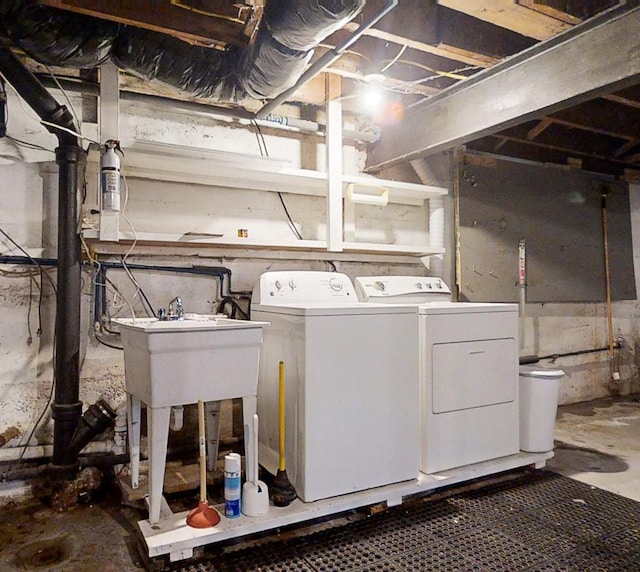 clothes washing area with separate washer and dryer