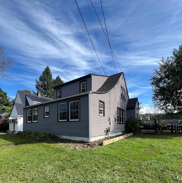 view of side of home with a yard