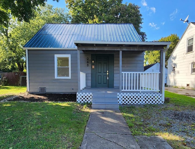 bungalow-style home with a front lawn and covered porch