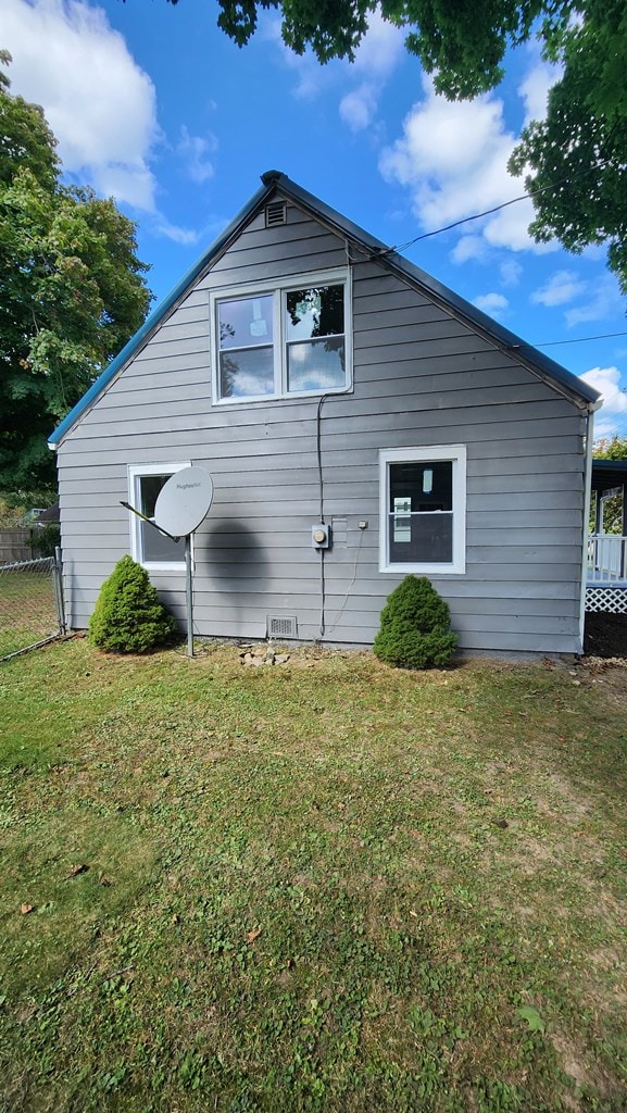 view of property exterior with a lawn