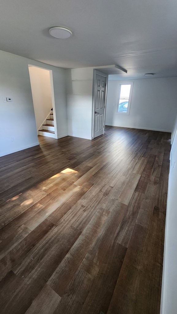 empty room featuring dark hardwood / wood-style flooring