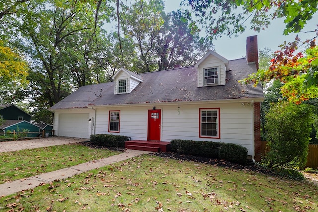 new england style home featuring a garage and a front lawn