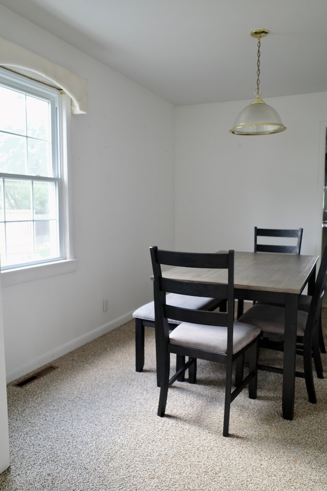 dining space featuring carpet