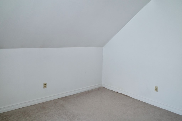 bonus room featuring light carpet and lofted ceiling