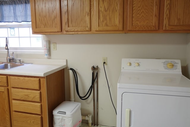 washroom with washer / dryer, sink, and cabinets