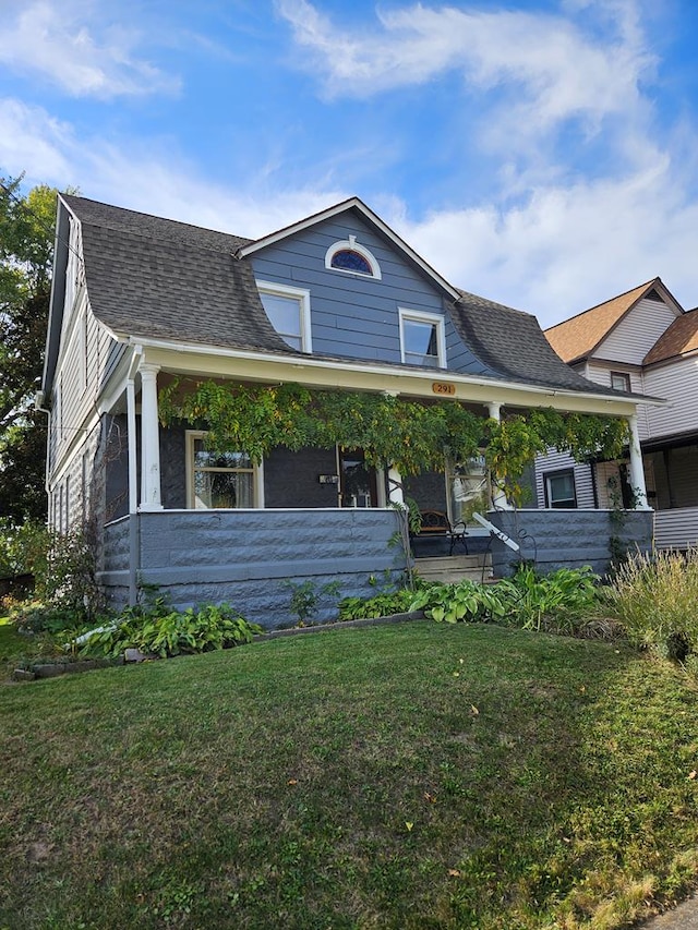 view of front of home with a porch and a front lawn