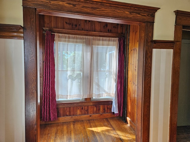 details featuring hardwood / wood-style flooring and wood walls