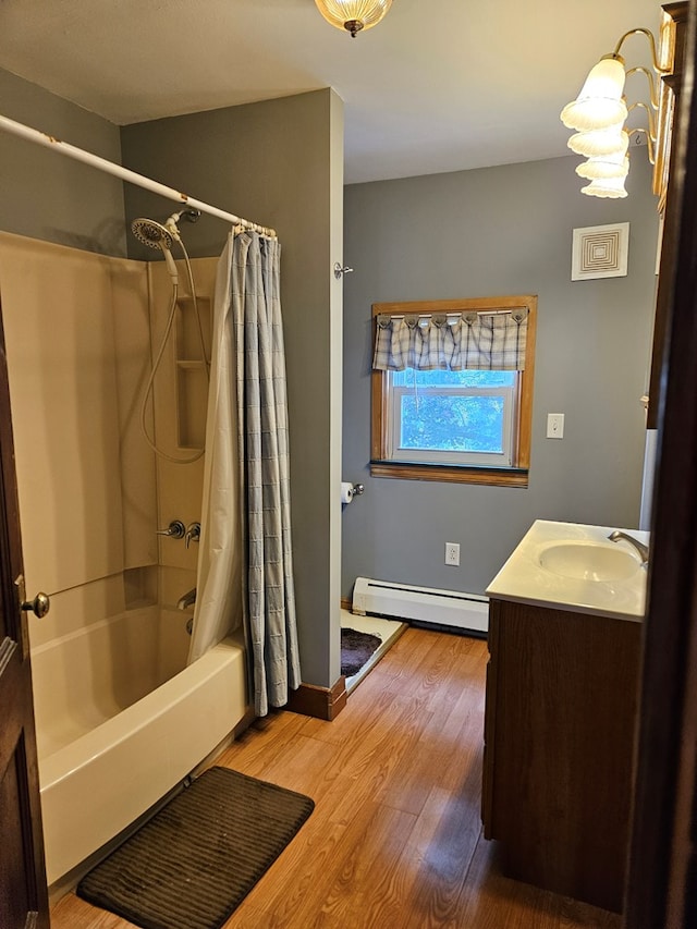 bathroom featuring hardwood / wood-style flooring, a baseboard radiator, vanity, and shower / bath combo with shower curtain