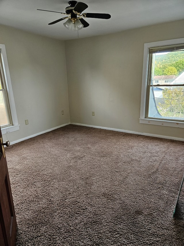 spare room featuring carpet floors and ceiling fan