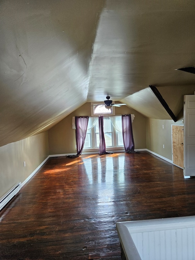 bonus room featuring lofted ceiling, a baseboard heating unit, dark hardwood / wood-style floors, and ceiling fan