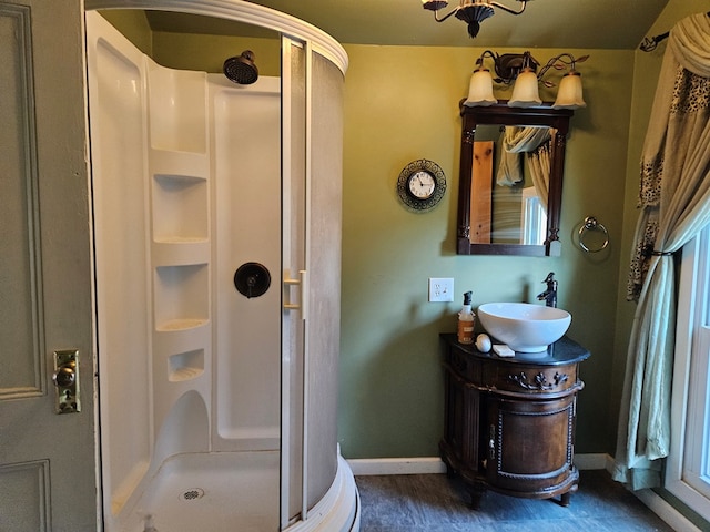 bathroom with vanity, hardwood / wood-style floors, and a shower with shower door