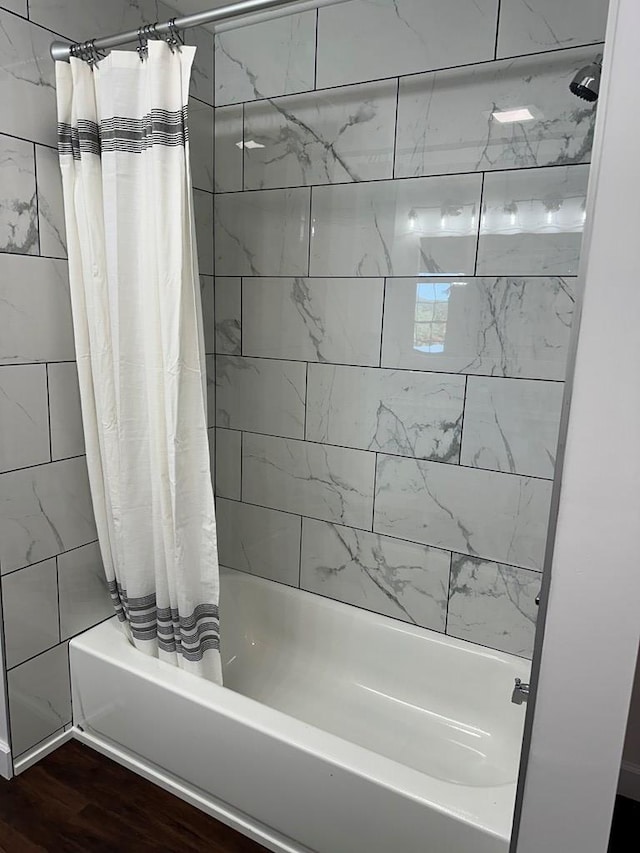 bathroom featuring shower / bath combo and hardwood / wood-style flooring