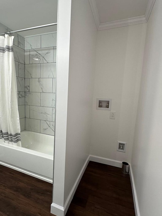 bathroom featuring hardwood / wood-style floors, shower / tub combo with curtain, and crown molding