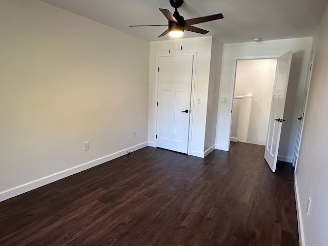 unfurnished bedroom with ceiling fan and dark hardwood / wood-style flooring