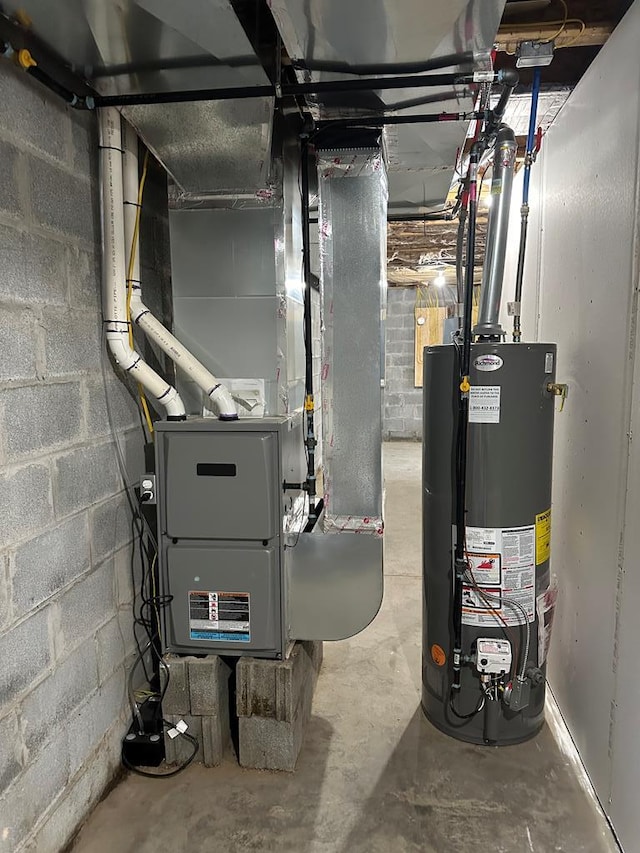 utility room featuring heating unit and water heater